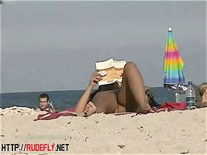 hot honeys filmed lying on a nudist beach